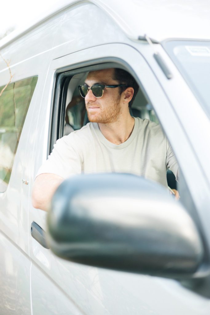 Guy sitting in driver seat and posing